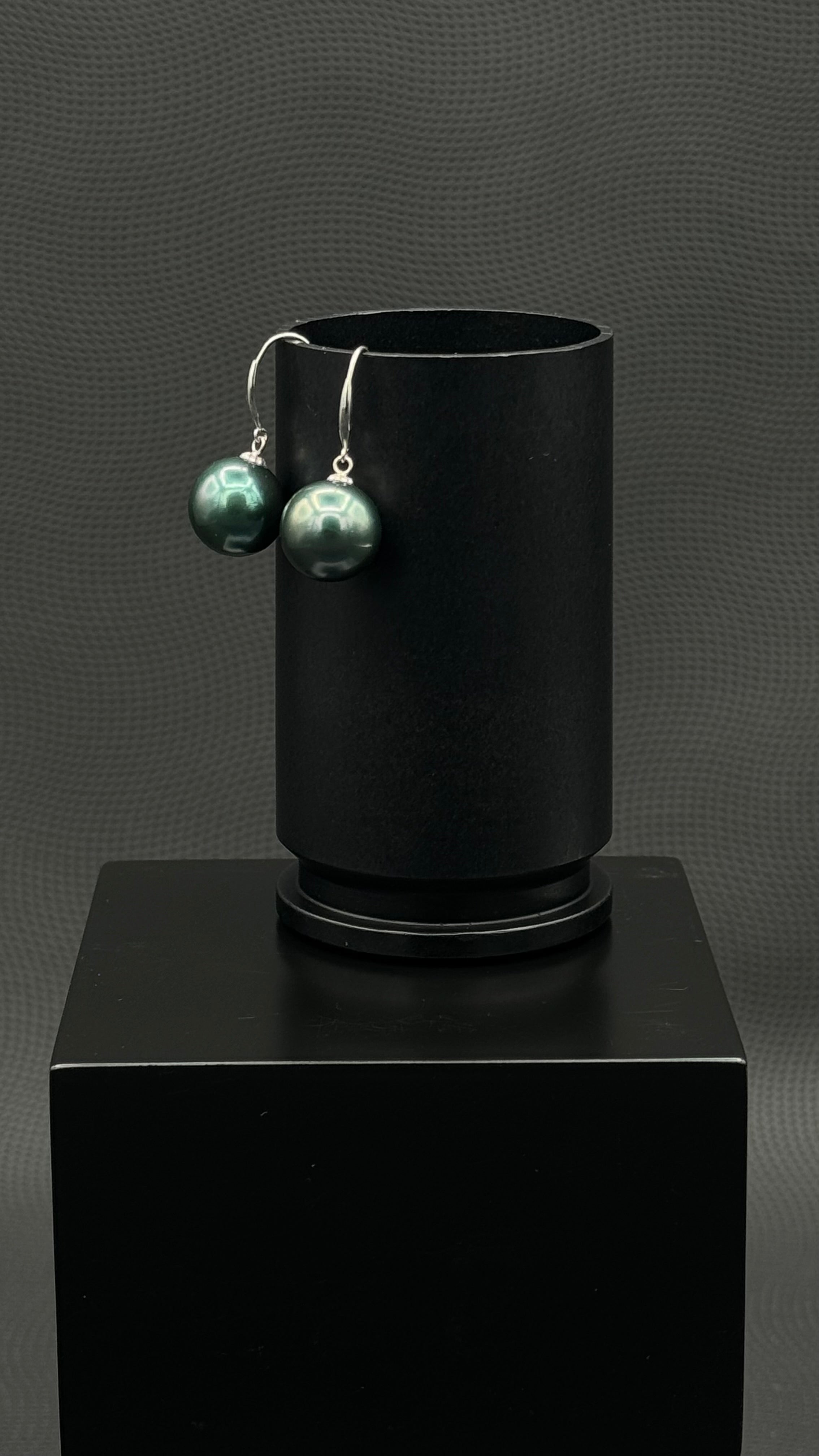 Cultured, Tahitian, pearl earrings, exhibited on black box, black-green, drop style, sound reflection, 11-12mm, 18k white gold.