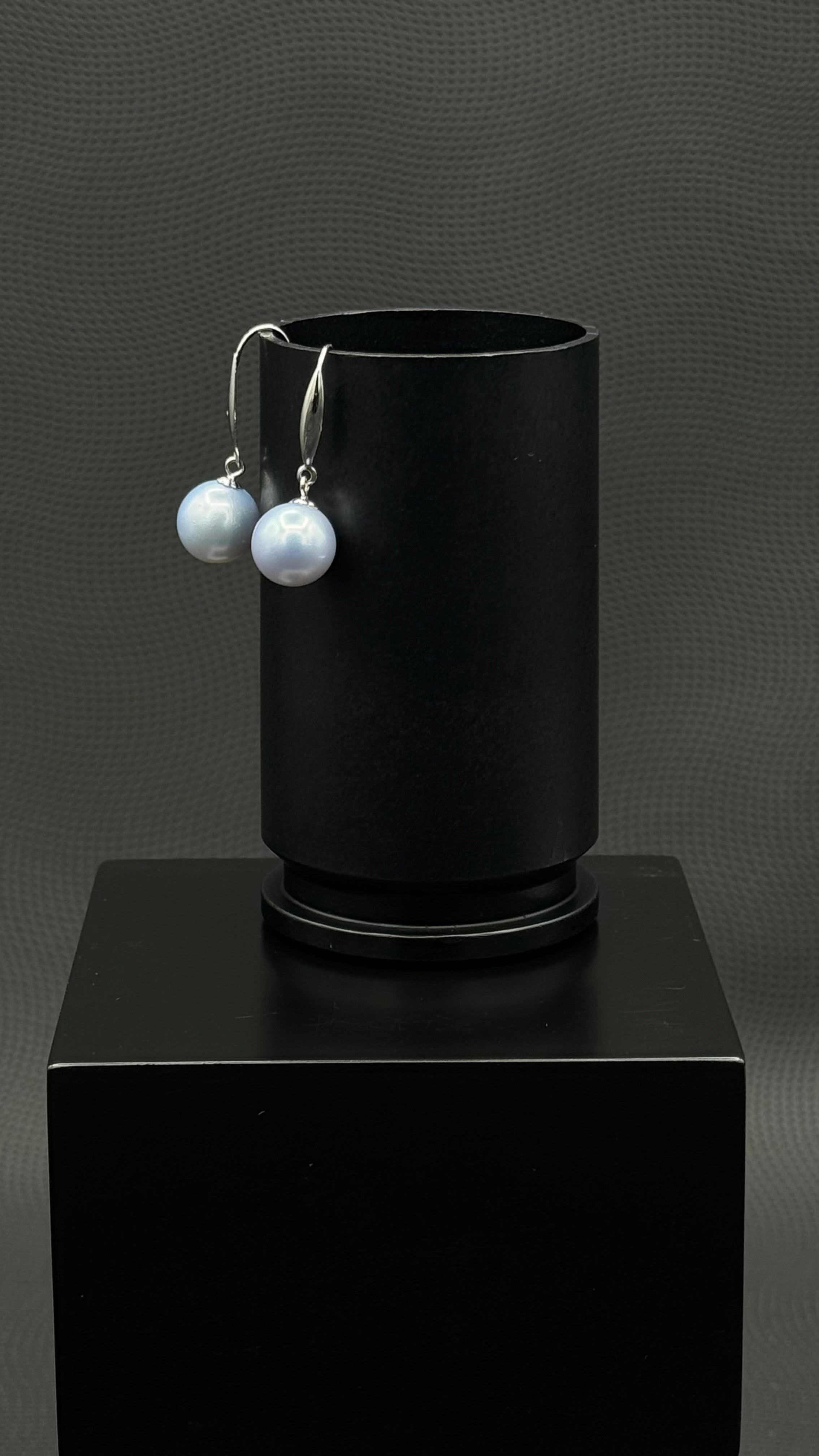 Cultured, South Sea, pearl earrings, exhibited on black box, light blue, drop style, excellent reflection, 10-11mm, 18k white gold.