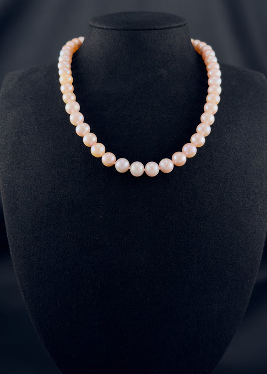 Cultured, South Sea soft-pink pearl strand necklace, exhibited on black suede, excellent reflection, 8.5-9.5mm, 17", yellow plated clasp.