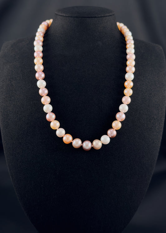 Cultured, South Sea mixed pink pearl strand necklace, exhibited on black suede, excellent reflection, 8-10mm, 20", yellow gold clasp.