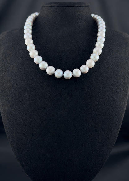 Cultured, South Sea soft grey pearl strand necklace, exhibited on black suede, sound reflection, 10.5-11mm, 18", white gold clasp.