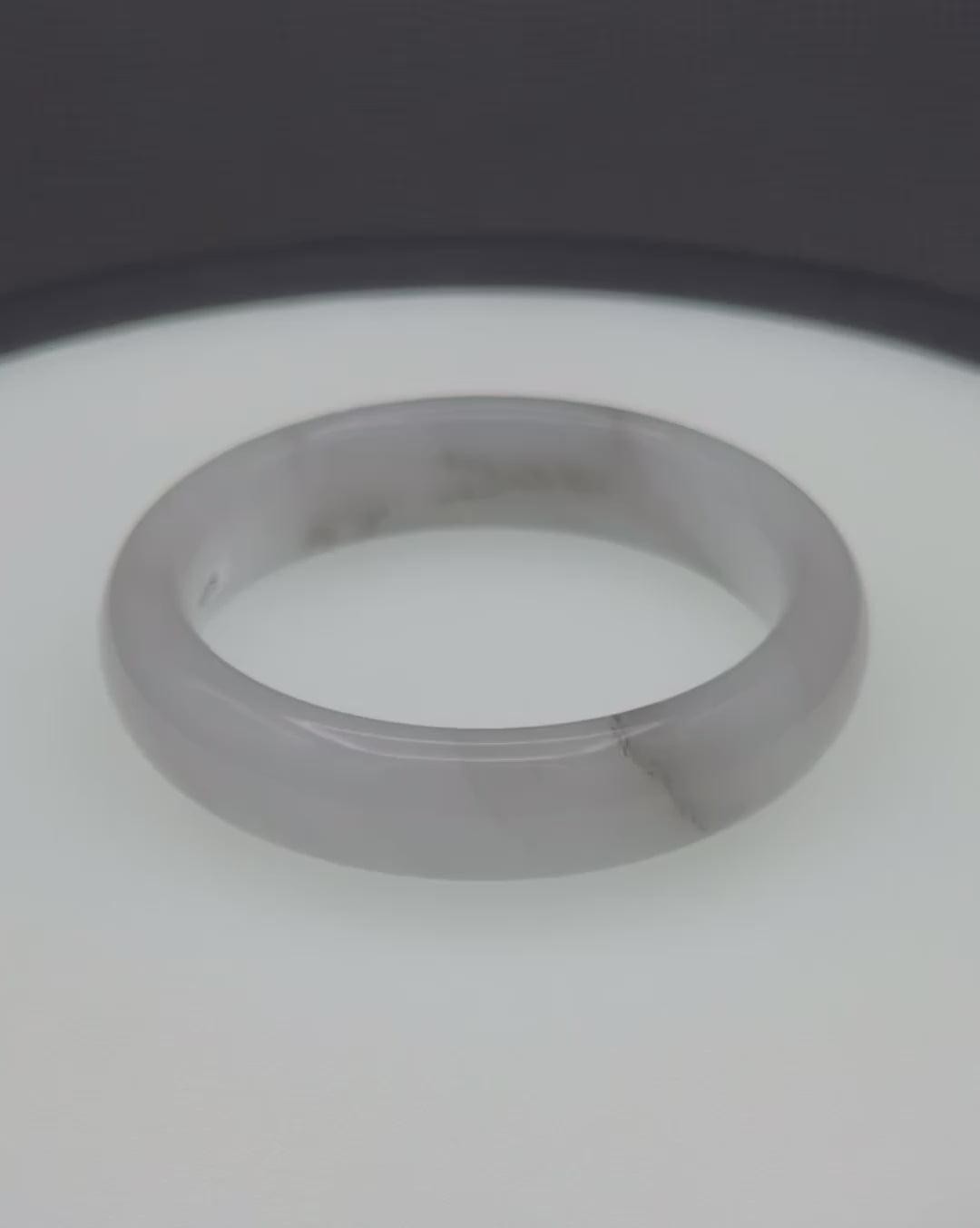 Gray agate bangle with smooth, polished surface and subtle natural banding.